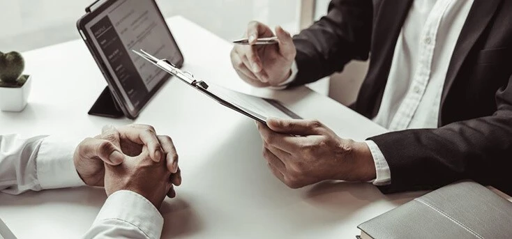 Taking notes in a job interview in a bright office