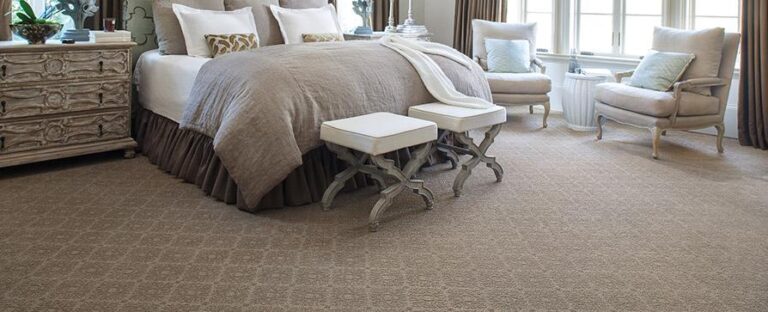 Comfortable modern bedroom setup with plush carpet flooring.