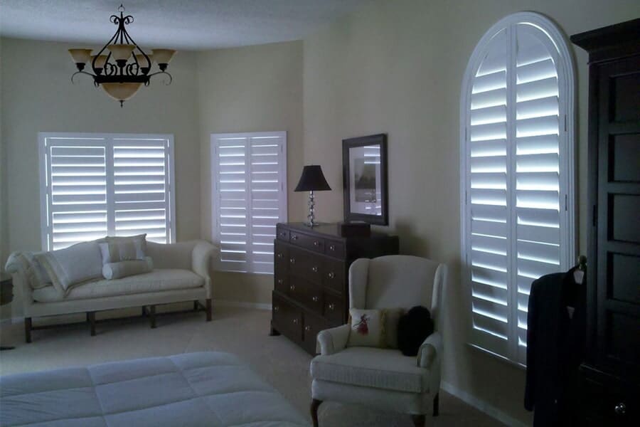 Bright living room with classic white plantation shutters