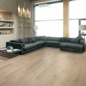 Warm brown Luxury Vinyl flooring in an open room with a large sectional sofa