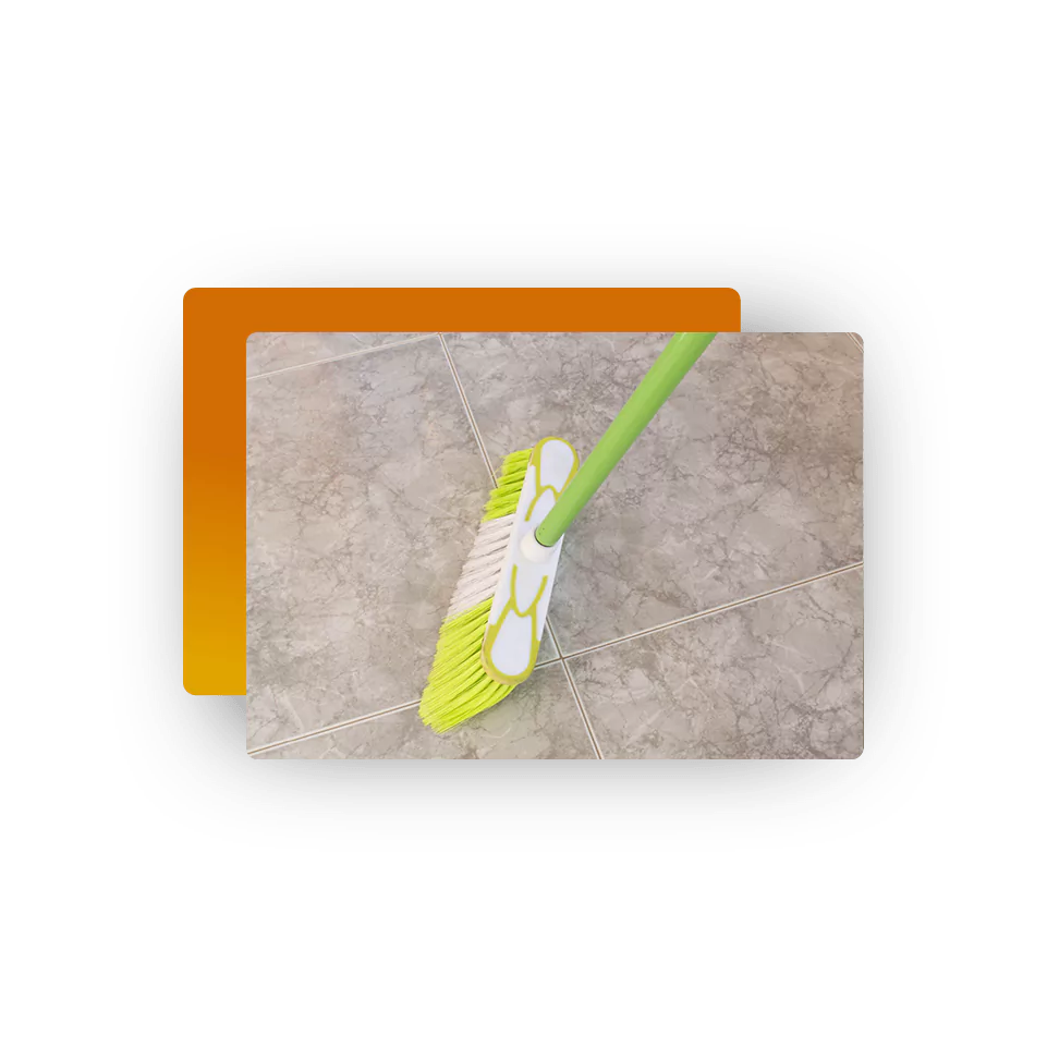 Sweeping tile flooring with a broom as part of daily tile care
