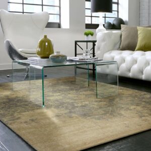 Olive green and beige area rug beneath a glass table in a white sofa seating area