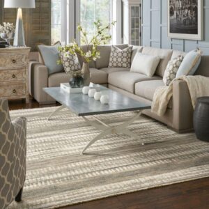Gray and ivory striped area rug in a light-filled living space with modern furniture