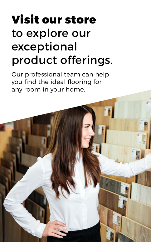 Smiling flooring consultant in a white shirt standing in front of sample flooring display, helping customers find ideal flooring options