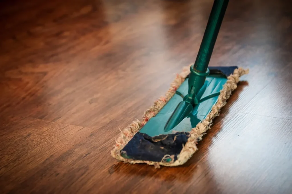 Green mop on hardwood