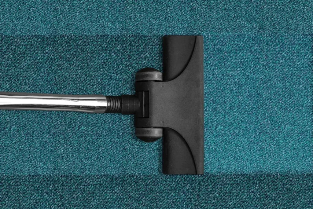 Vacuum cleaner head on blue carpet
