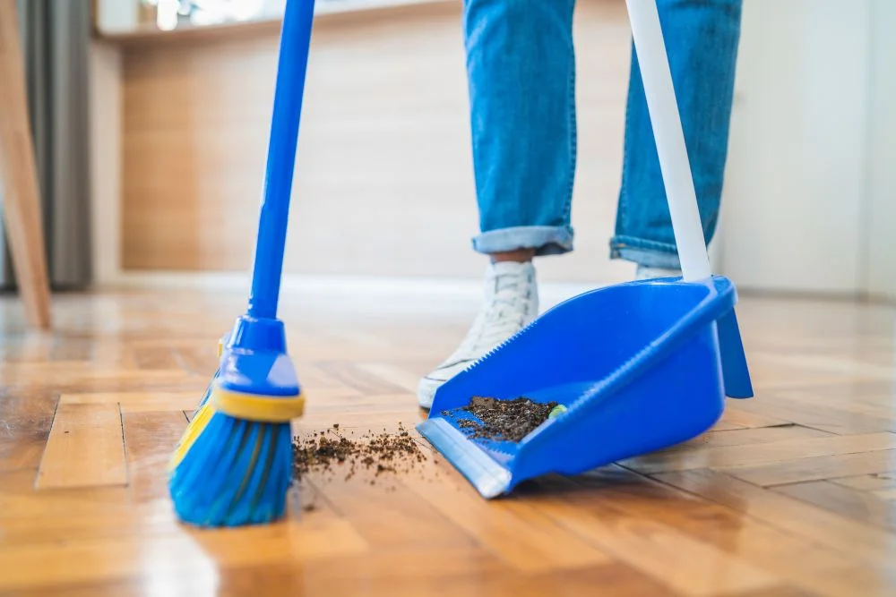 Woman sweeping hardwood floors