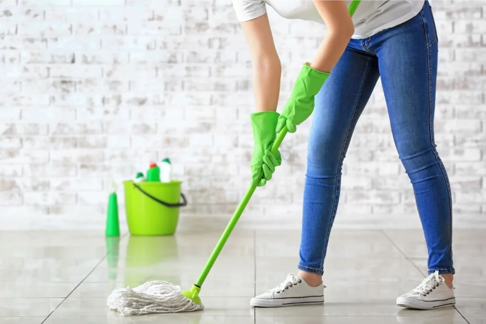 Woman mopping tile flooring