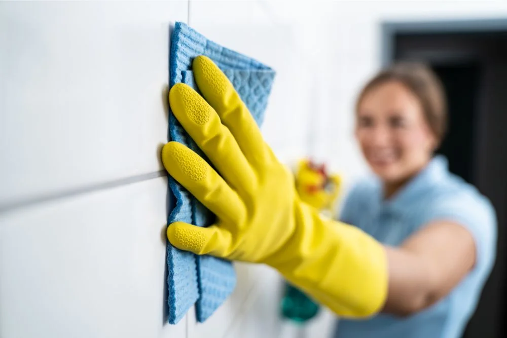 Woman cleaning white tile