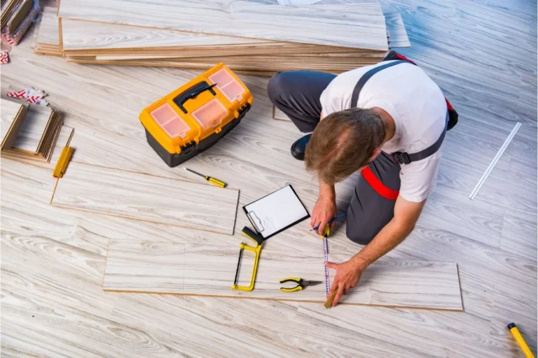 Flooring professional installing laminate