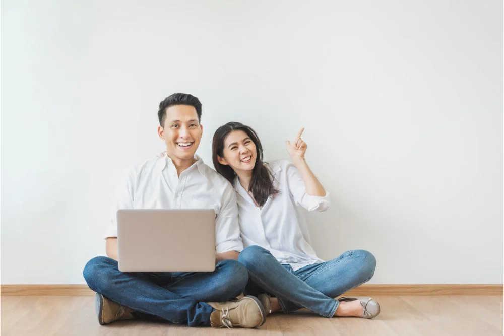 Happy couple visualizing flooring products on their laptop