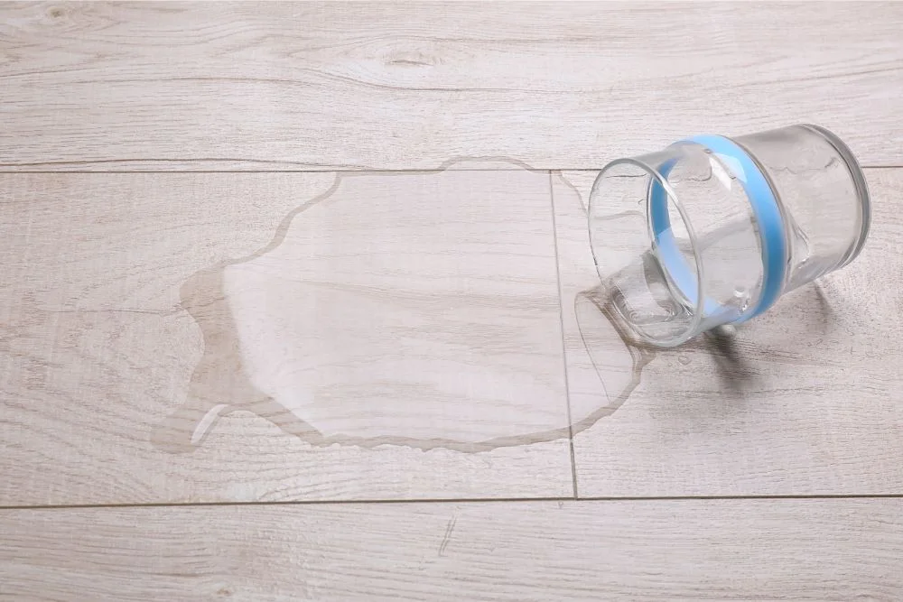 Glass of water spilled on luxury vinyl floors