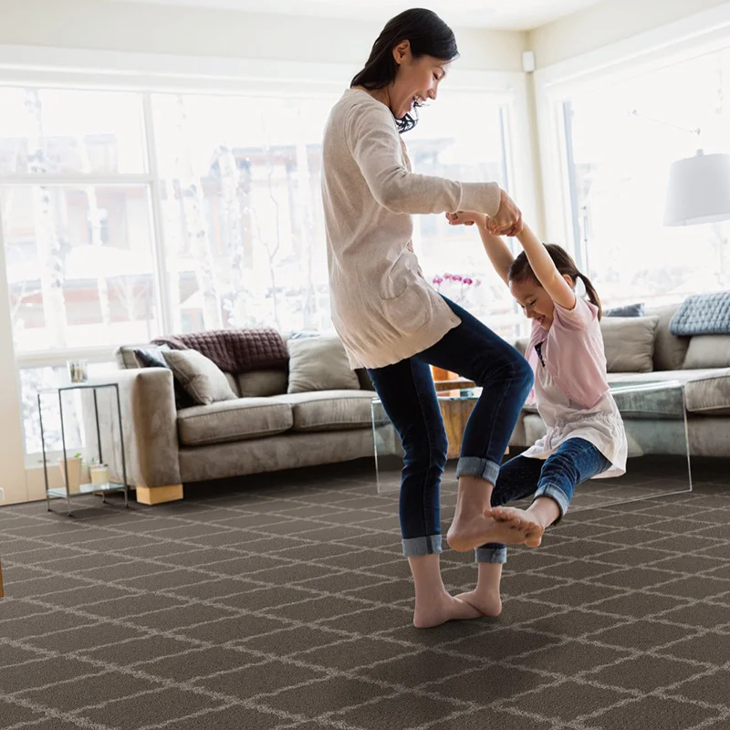 Mother and daughter playing on carpet