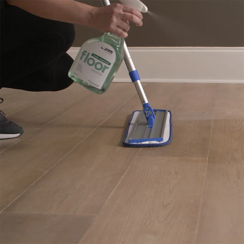 Person cleaning hardwood flooring