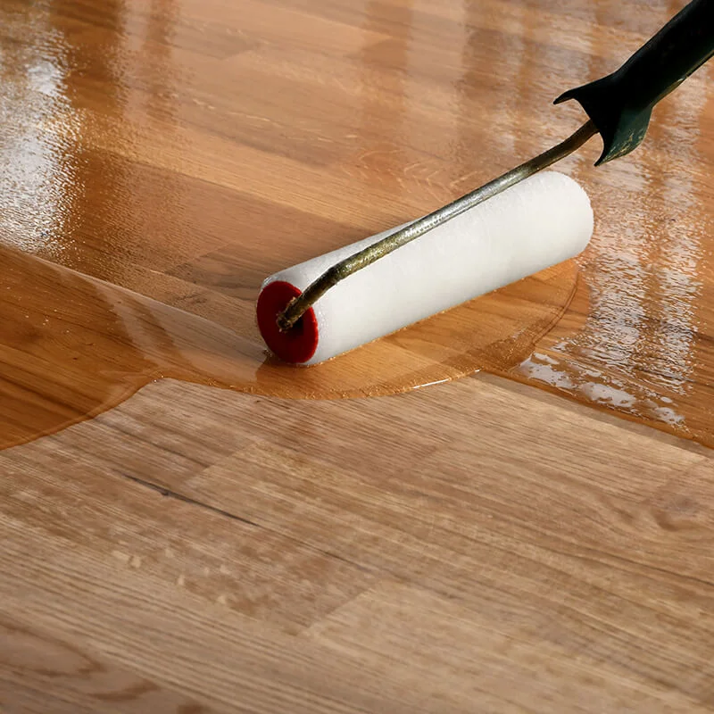 Person refinishing hardwood flooring